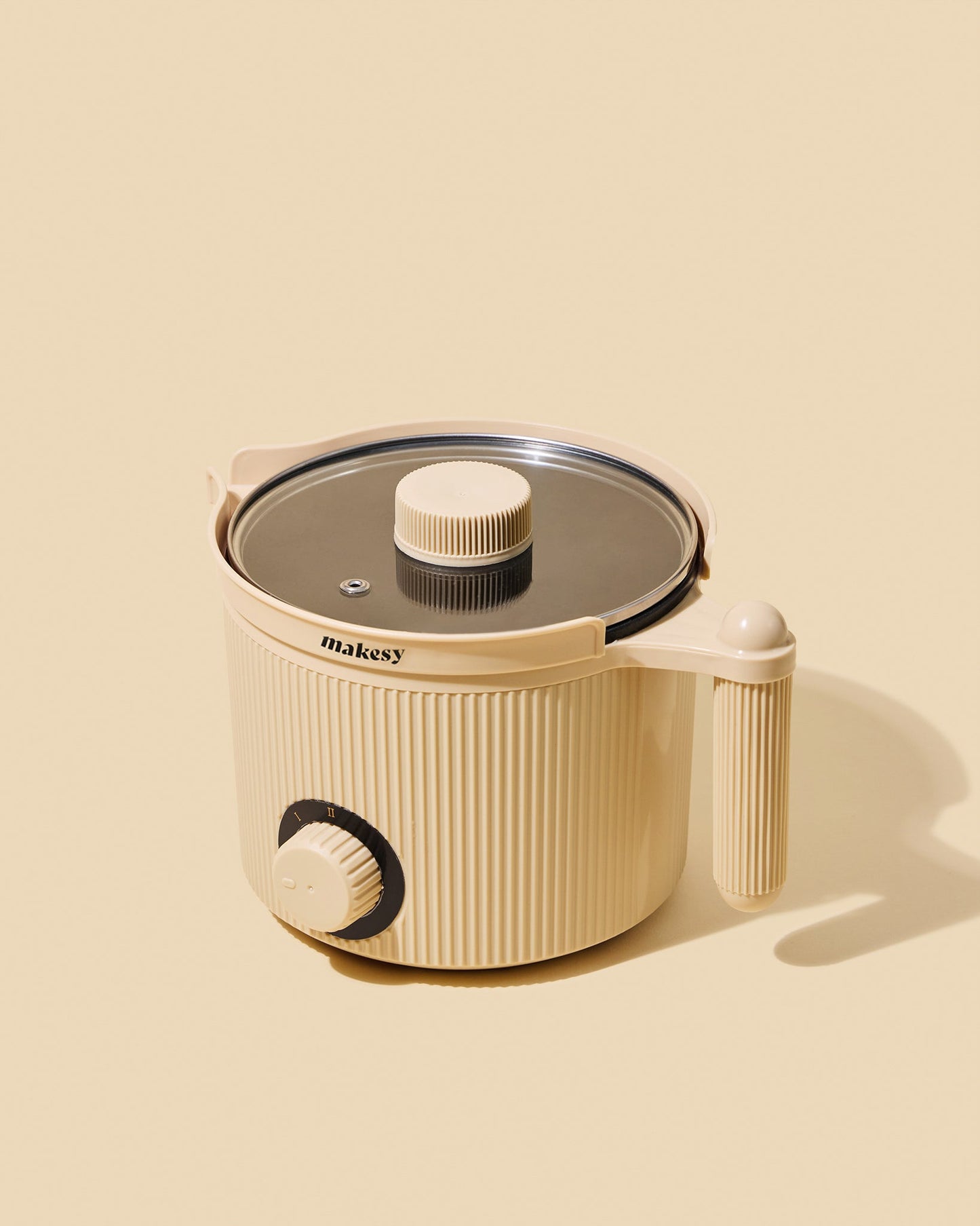 Beige kitchen appliance with lid on a beige background