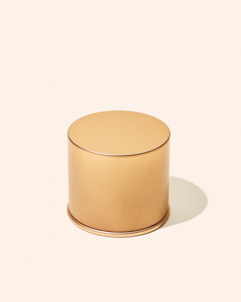 Gold cylindrical container on a white background