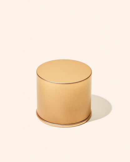 Gold cylindrical container on a white background