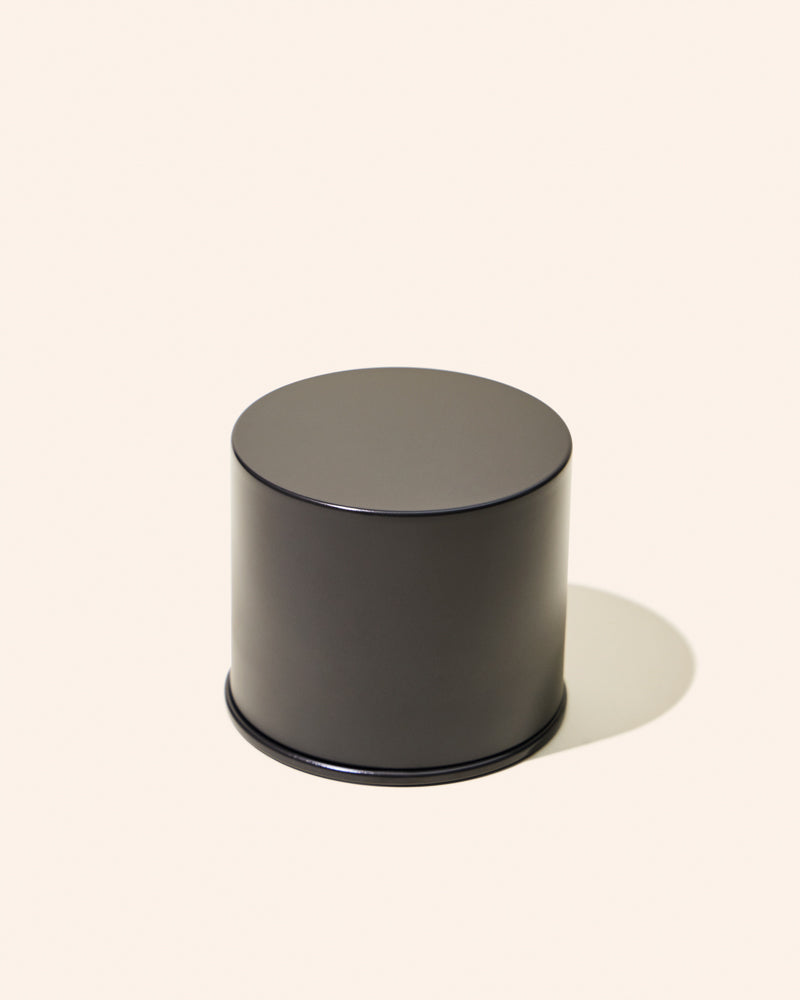 Black cylindrical container on a white background