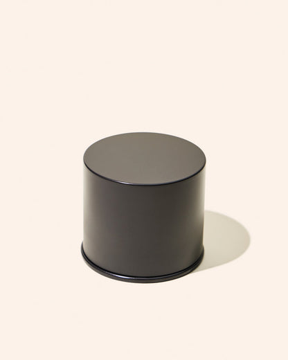 Black cylindrical container on a white background