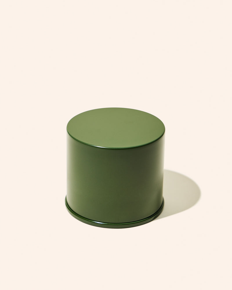 Green cylindrical container on a white background
