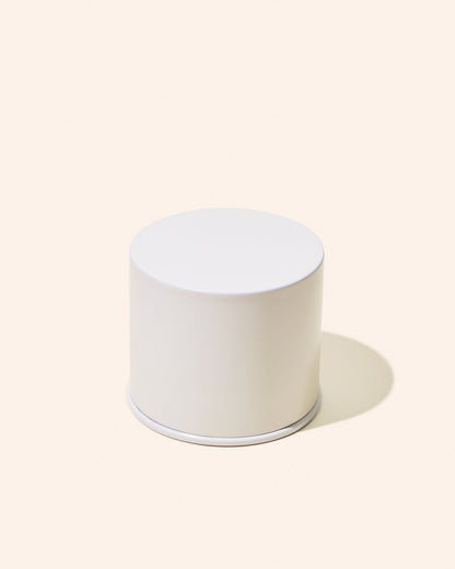 White cylindrical object on a light beige background