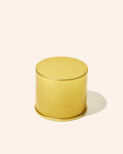 Gold cylindrical container on a white background