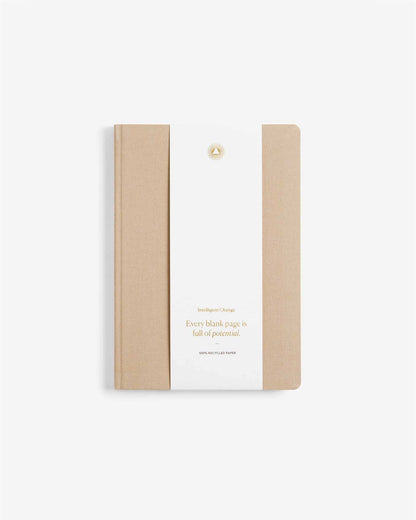 Notebook with beige cover and white back on a light beige background