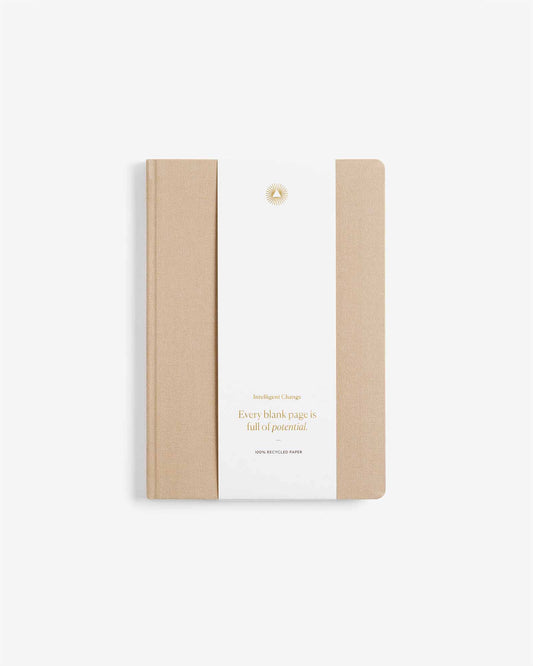 Notebook with beige cover and white back on a light beige background