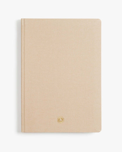 Beige notebook with a gold logo on a white background