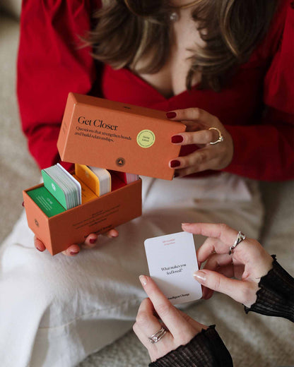 Person holding a card from a 'Get Closer' product packaging