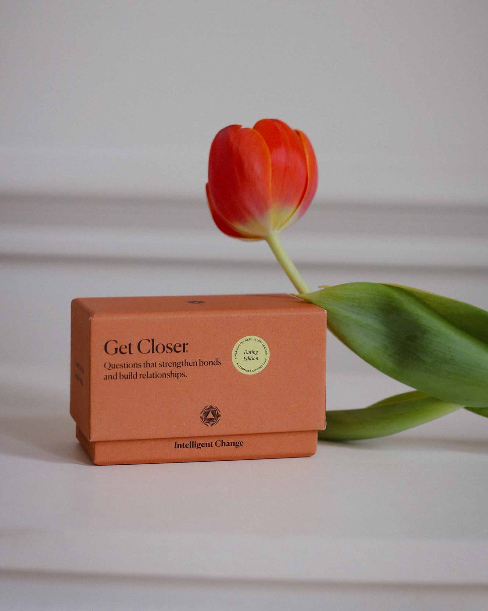 Orange box labeled 'Get Closer' with a red tulip on a light background