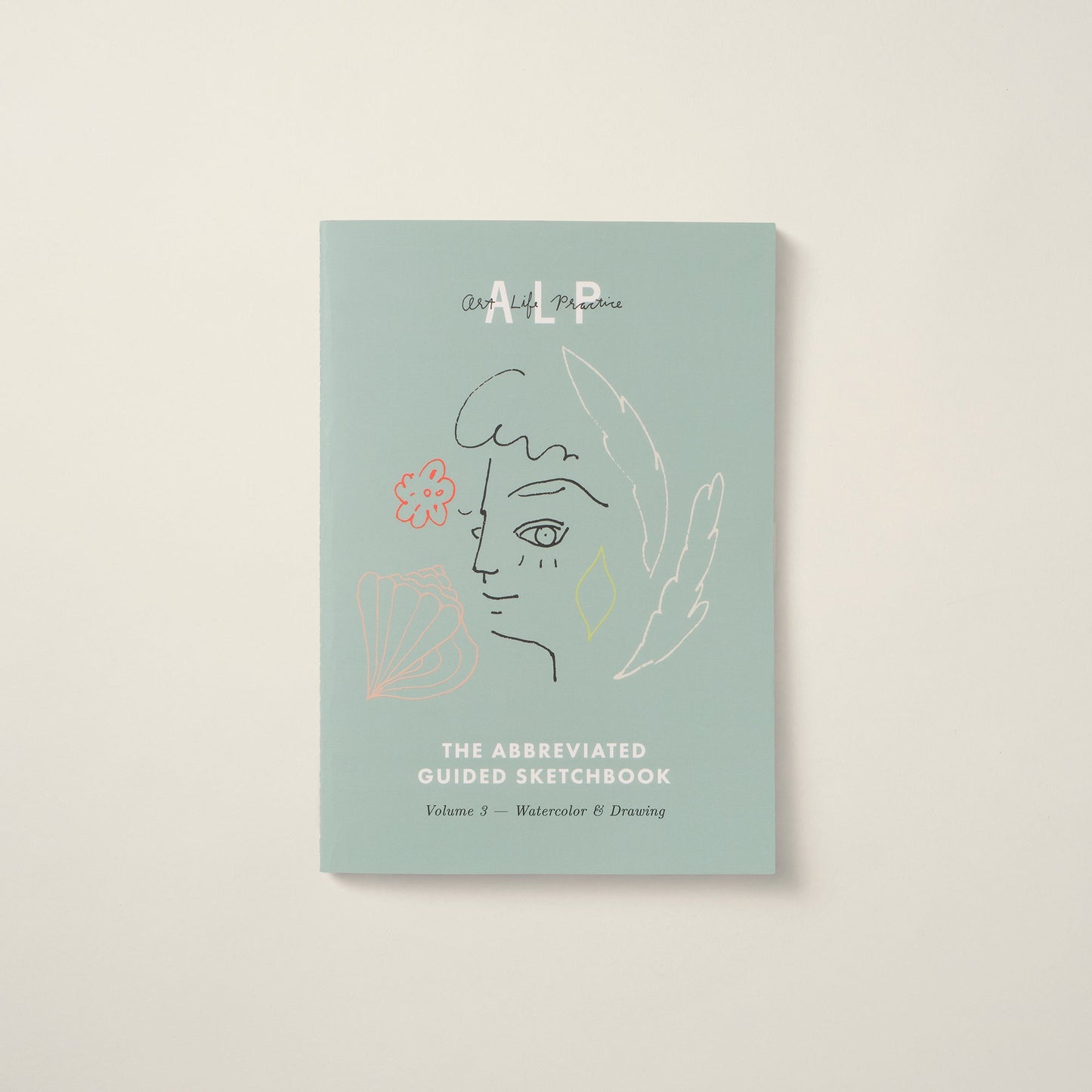 Light blue guided sketchbook with artistic design on a beige background