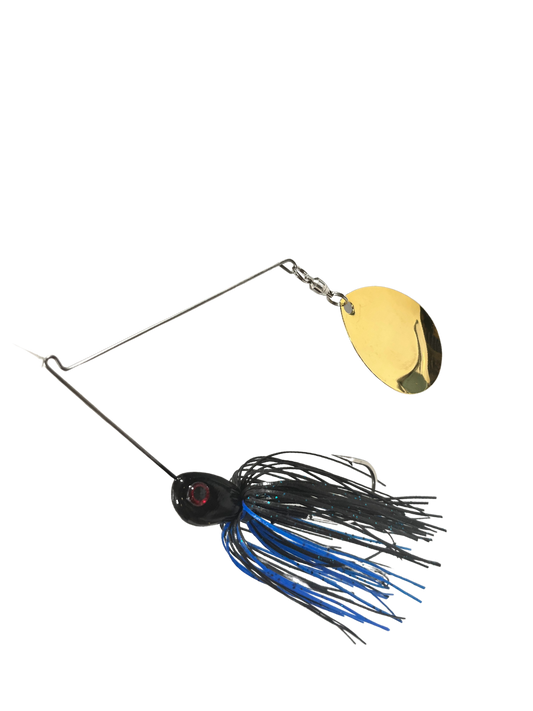 Fishing spinner with a yellow blade and blue and black skirt on a white background