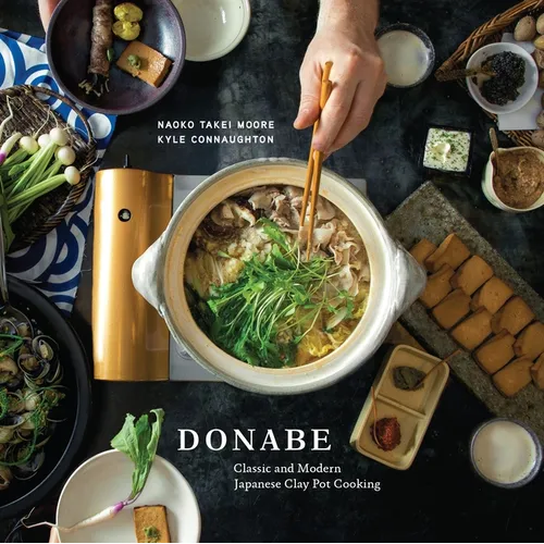 Book cover of 'Donabe' with a bowl of soup, chopsticks, and various Japanese foods on a dark background.