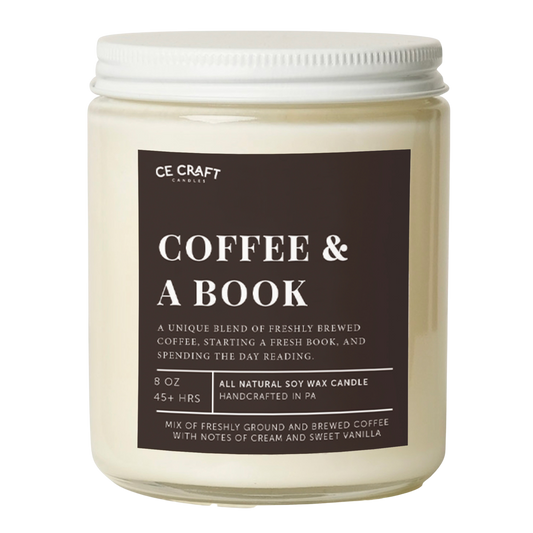 An 8 oz soy wax candle by CE CRAFT COCKTAILS in a clear glass jar with a white lid, featuring a dark brown label with white text that reads 'COFFEE & A BOOK'.