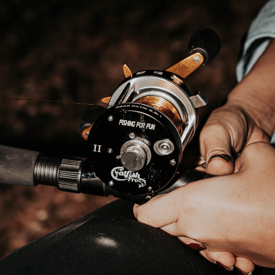 Fishing reel being held by a person with a blurred background